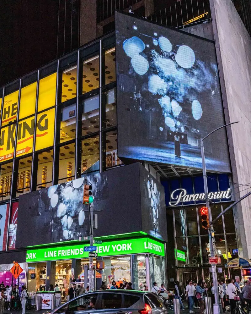 Click pictures at the Times Square. (Photo By: Joshua Earle)