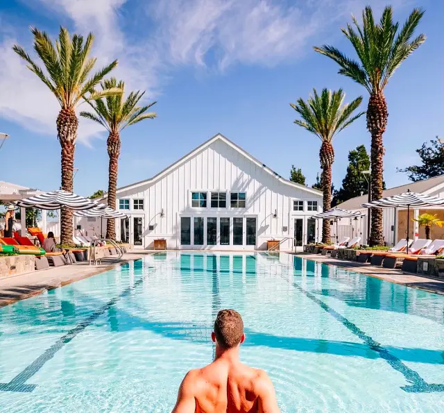 A man cooling off on the pool at Carneros R&S on a sunny day