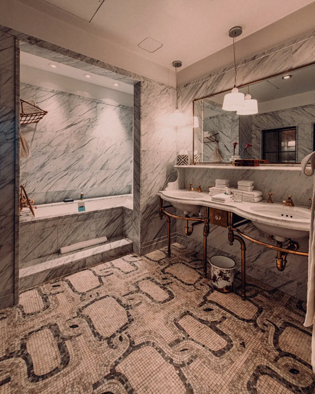 The Greenwich Hotel bathrooms offer elegant designs of marble, brass, and spa-worthy essentials.